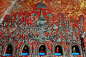 Myanmar, Burma, Nyaungshwe. Small Buddhas set into the temple wall, Shwe Yaunghwe Kyaung monastery, near Inle Lake. 